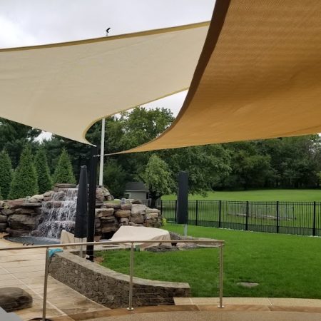 Pool with waterfall and shade sails