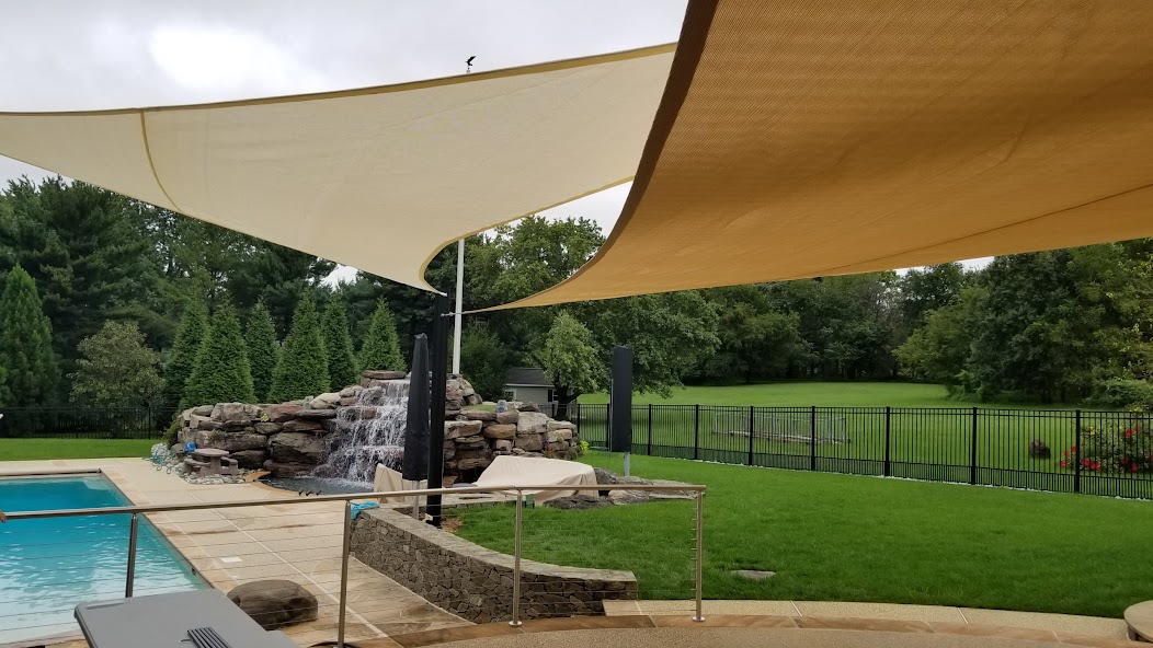 Pool with waterfall and shade sails